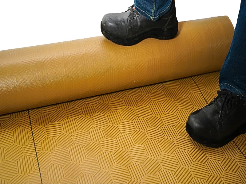 Contractor walking on Gator Guard Gold temporary floor protection during installation. Tear-resistant, liquid-absorbent, and built for construction site durability.
