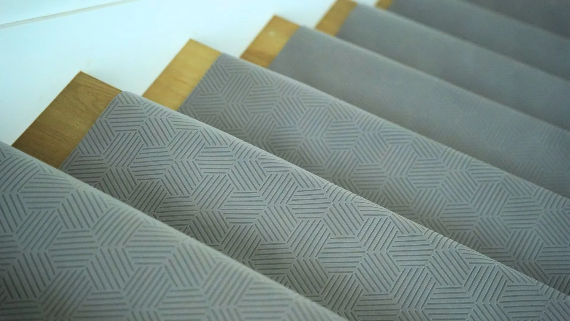 Gator Guard gray textured floor protection installed on wooden stairs during renovation